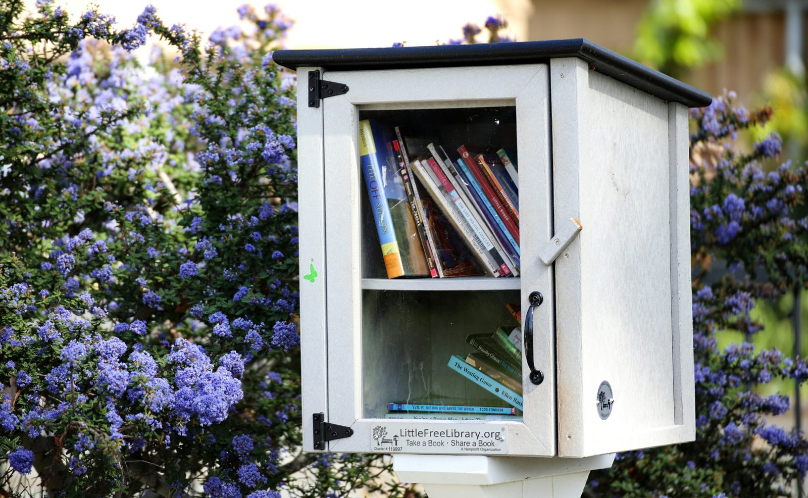 a white mailbox with a bunch of books in it